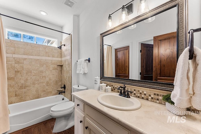 full bathroom with toilet, vanity, shower / bath combo, hardwood / wood-style floors, and backsplash