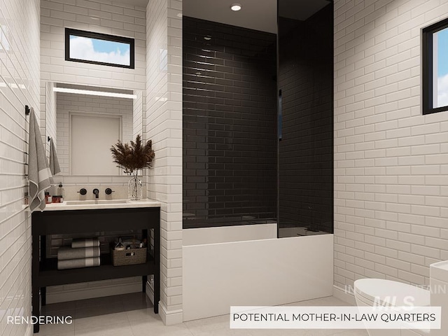 bathroom featuring tile patterned flooring, vanity, tile walls, and toilet