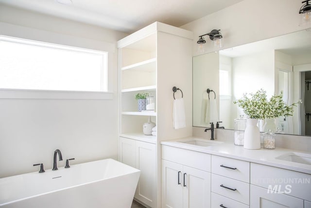 6104 S Apex Ave, Meridian, ID 83642 - full bath with healthy amount of natural light, a freestanding tub, and double vanity