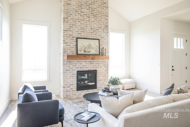 6104 S Apex Ave, Meridian, ID 83642 - living room with lofted ceiling, wood finished floors, and a fireplace