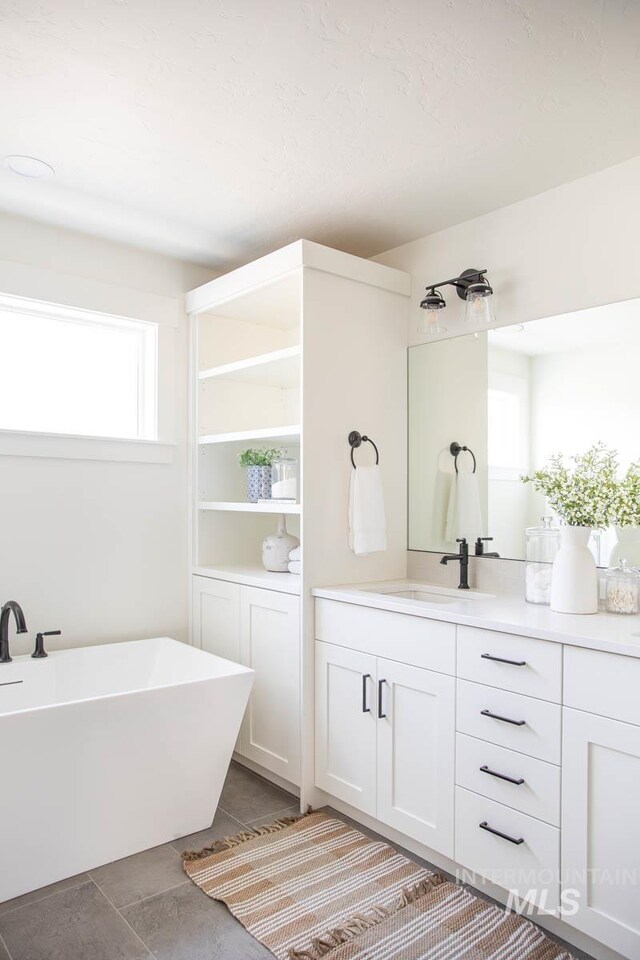 6104 S Apex Ave, Meridian, ID 83642 - bathroom with a soaking tub and vanity