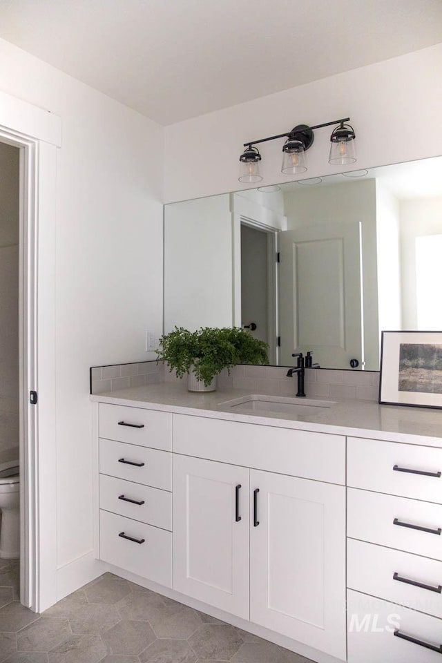 6104 S Apex Ave, Meridian, ID 83642 - bathroom featuring vanity and toilet