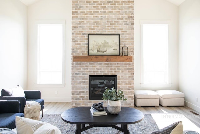 6104 S Apex Ave, Meridian, ID 83642 - living area with lofted ceiling, wood finished floors, and a fireplace