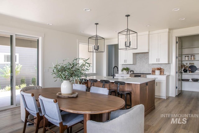 6104 S Apex Ave, Meridian, ID 83642 - dining room with light wood-style floors, recessed lighting, and a chandelier