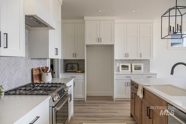 6104 S Apex Ave, Meridian, ID 83642 - kitchen featuring stainless steel appliances, tasteful backsplash, white cabinetry, light wood-type flooring, and recessed lighting