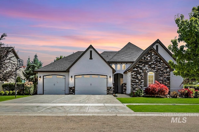 view of front of home with a lawn and a garage