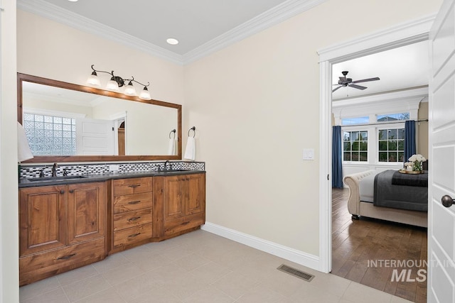 bathroom featuring hardwood / wood-style floors, ceiling fan, vanity, and ornamental molding