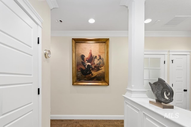 hall featuring crown molding and decorative columns