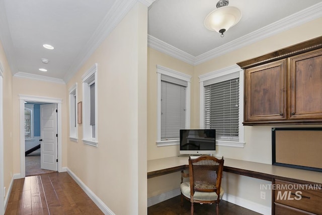 home office featuring ornamental molding, built in desk, and dark hardwood / wood-style floors