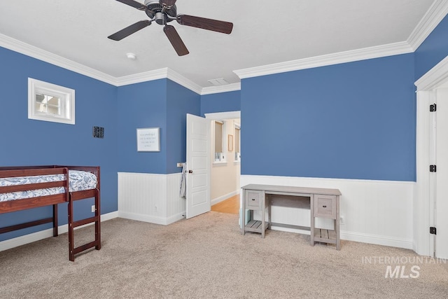 carpeted bedroom featuring ceiling fan and ornamental molding