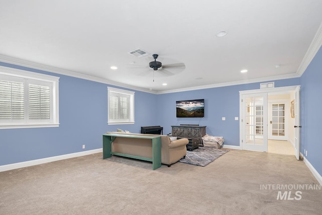 living room featuring crown molding, french doors, light colored carpet, and ceiling fan