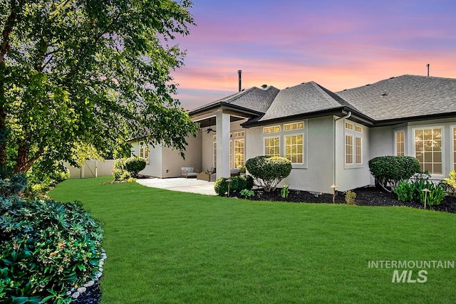 exterior space featuring a lawn and a patio area