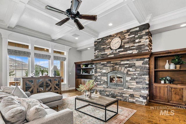 living room featuring a fireplace, light hardwood / wood-style floors, coffered ceiling, ceiling fan, and beam ceiling