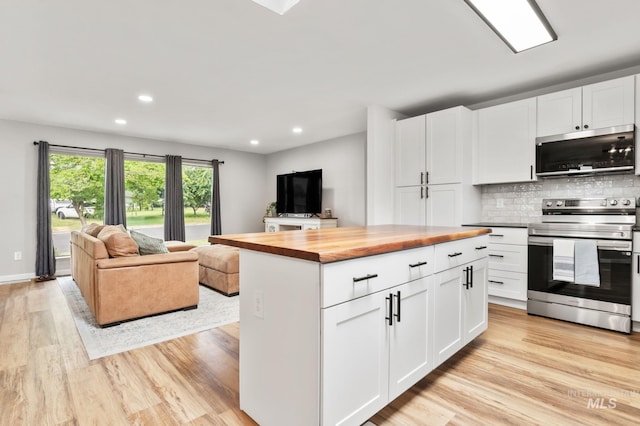 3513 7th St E, Lewiston, ID 83501 - kitchen with appliances with stainless steel finishes, butcher block counters, open floor plan, light wood finished floors, and recessed lighting