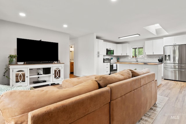 3513 7th St E, Lewiston, ID 83501 - living area with a skylight, light wood-type flooring, and recessed lighting