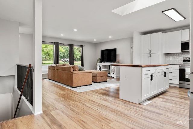 3513 7th St E, Lewiston, ID 83501 - kitchen with stainless steel appliances, butcher block counters, light wood-style floors, open floor plan, and recessed lighting