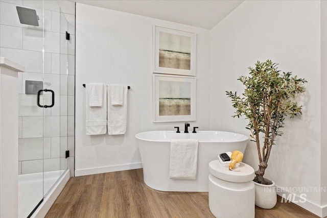 bathroom with separate shower and tub and hardwood / wood-style floors