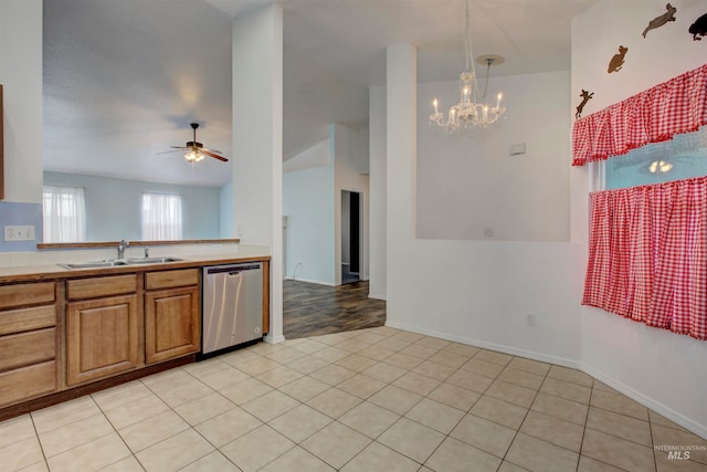 kitchen featuring dishwasher, sink, hanging light fixtures, light hardwood / wood-style flooring, and ceiling fan with notable chandelier