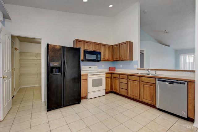 kitchen with sink, light tile patterned flooring, black appliances, and high vaulted ceiling