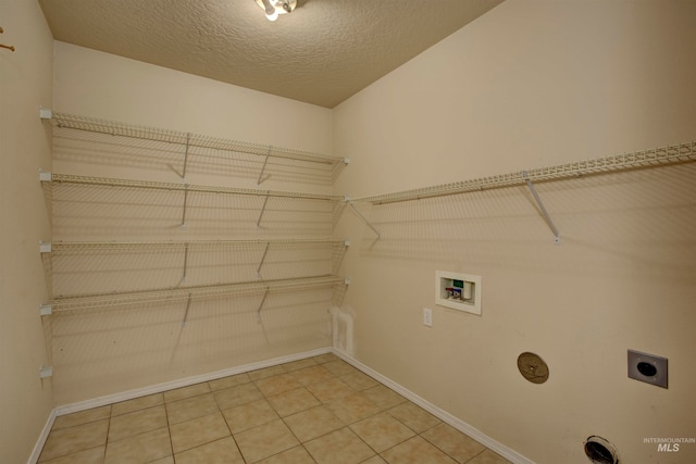 washroom featuring electric dryer hookup, a textured ceiling, and hookup for a washing machine