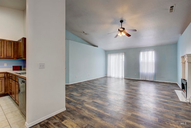 unfurnished living room featuring light hardwood / wood-style floors, vaulted ceiling, and ceiling fan