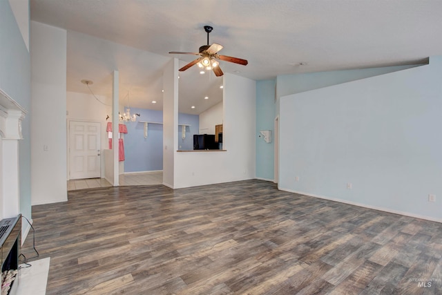 unfurnished living room featuring ceiling fan with notable chandelier, lofted ceiling, and dark wood-type flooring