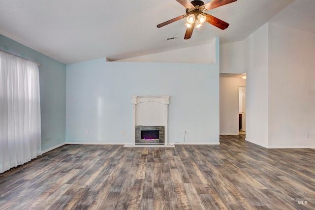 unfurnished living room with a stone fireplace, ceiling fan, dark hardwood / wood-style floors, and lofted ceiling