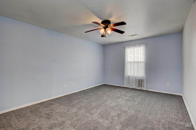 carpeted empty room with ceiling fan and a textured ceiling