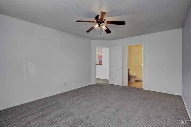 unfurnished bedroom featuring ceiling fan, ensuite bathroom, a textured ceiling, and light carpet