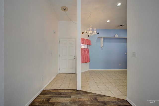 interior space with light tile patterned floors and a notable chandelier