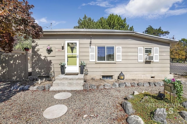 view of front of property with fence and cooling unit