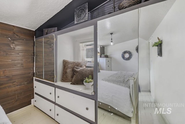 bathroom featuring a textured ceiling and vaulted ceiling