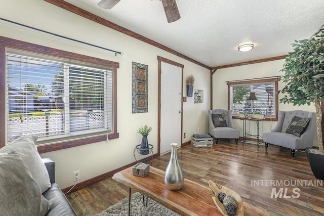 sitting room featuring a textured ceiling, wood finished floors, ceiling fan, and ornamental molding