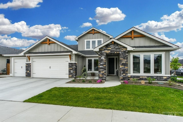 craftsman-style home with board and batten siding, an attached garage, stone siding, and a front lawn