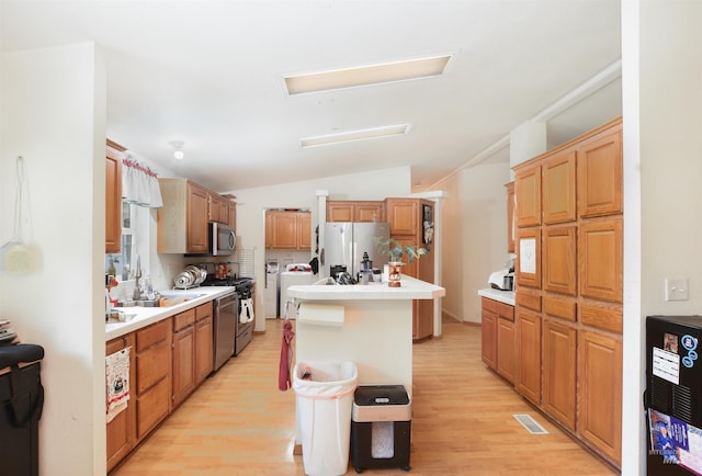 518 N 42nd, Nampa, ID 83687 - kitchen with separate washer and dryer, light countertops, appliances with stainless steel finishes, light wood-type flooring, and lofted ceiling