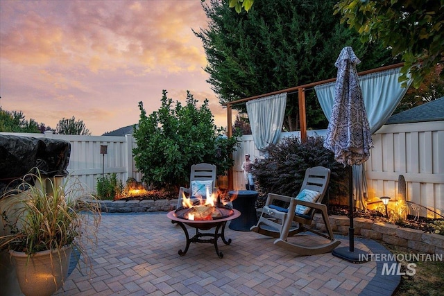 patio terrace at dusk with an outdoor fire pit