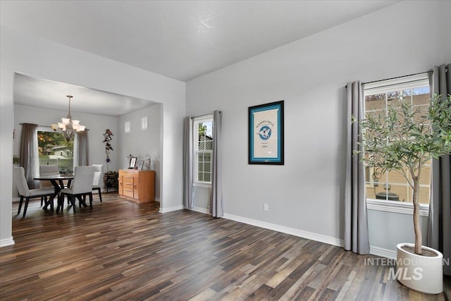 dining area with a chandelier and dark hardwood / wood-style floors