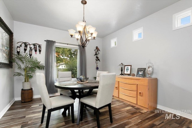 dining room featuring an inviting chandelier and dark hardwood / wood-style flooring