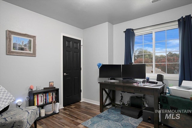 home office with dark hardwood / wood-style floors