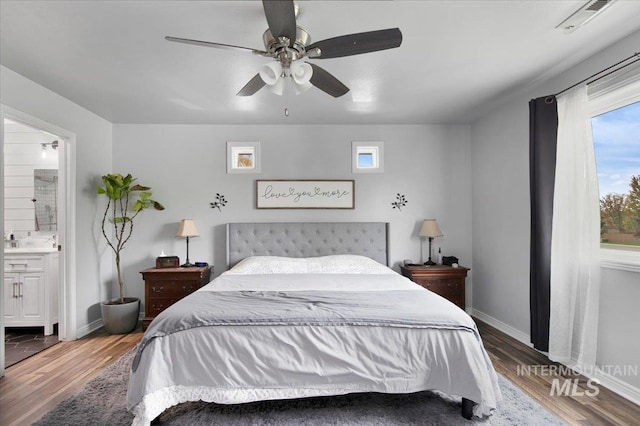 bedroom with ensuite bathroom, hardwood / wood-style flooring, and ceiling fan