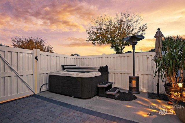 patio terrace at dusk with a hot tub