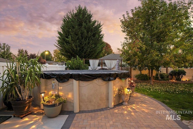 view of patio terrace at dusk