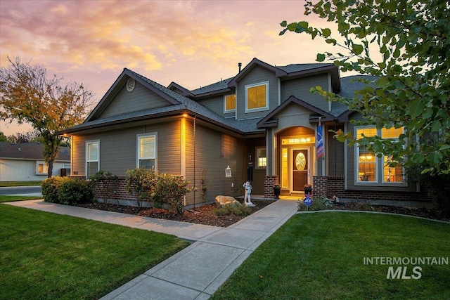 craftsman-style home with a yard