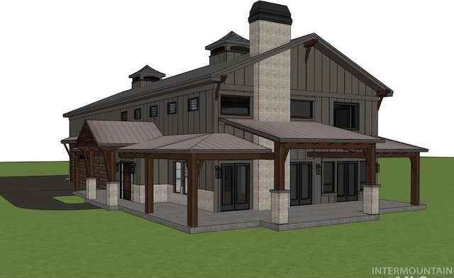 rear view of house featuring metal roof, a chimney, a standing seam roof, and board and batten siding