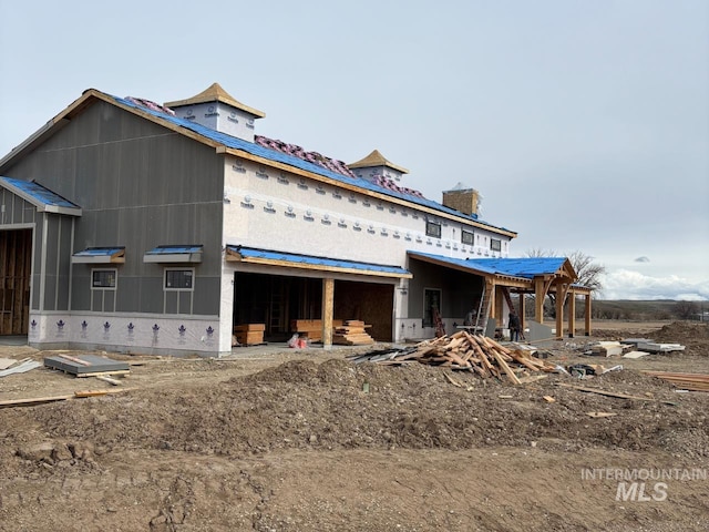 property in mid-construction with a chimney