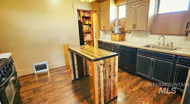 kitchen featuring visible vents, black appliances, a sink, dark wood finished floors, and dark cabinets