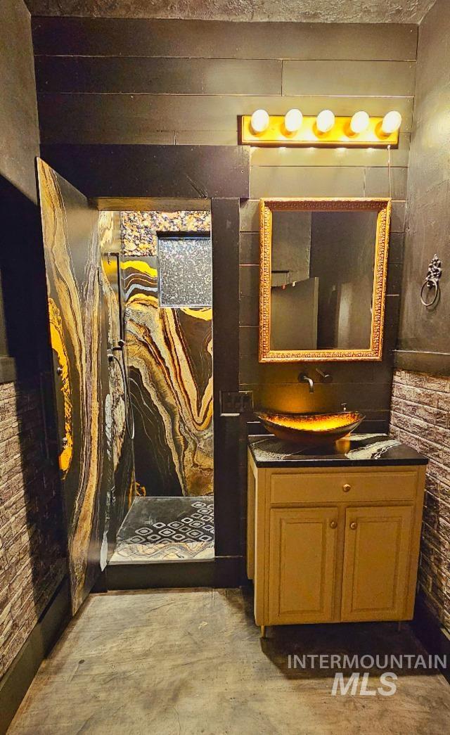 bathroom with a walk in shower and vanity