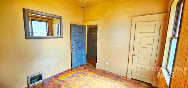 spare room featuring wood finished floors