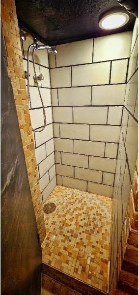 full bathroom with a tile shower