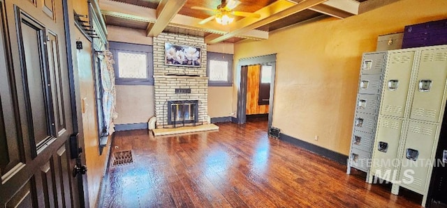 unfurnished living room featuring beam ceiling, a ceiling fan, coffered ceiling, wood finished floors, and baseboards